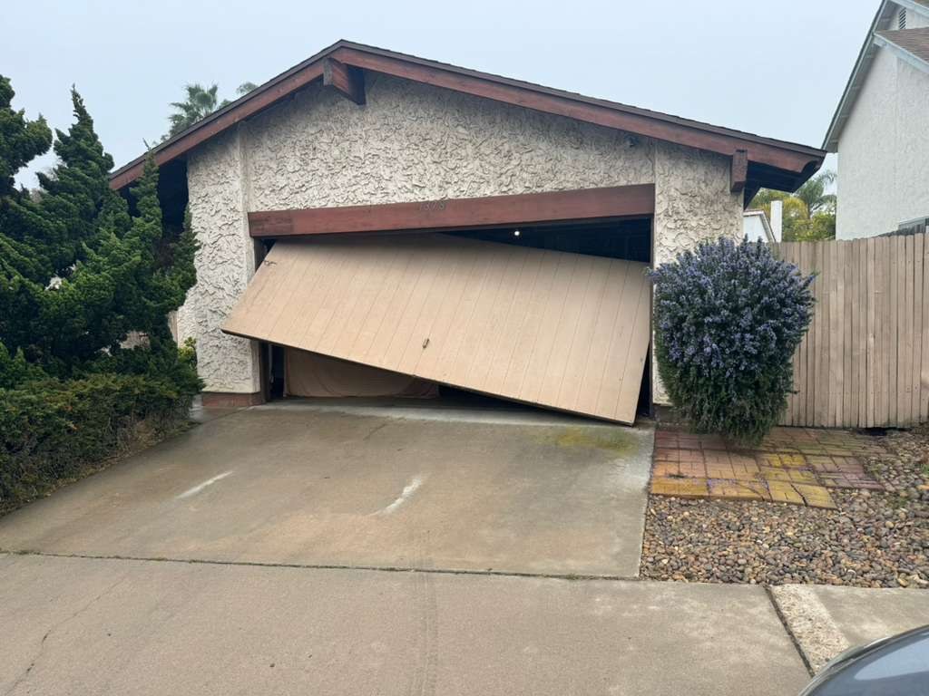 A garage door that has come off its track at a San Diego home
