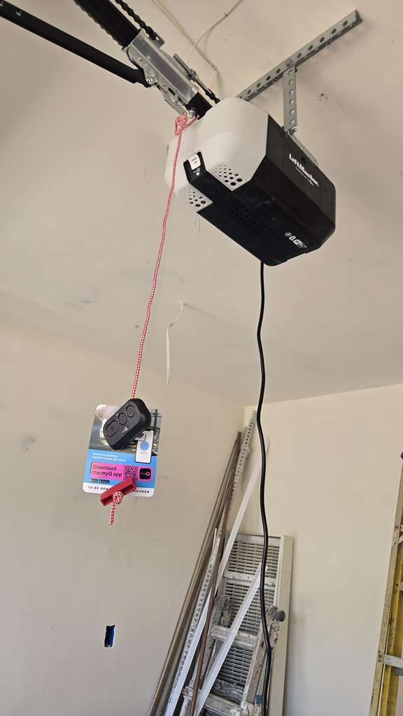 A chain-drive garage door opener installed inside a garage