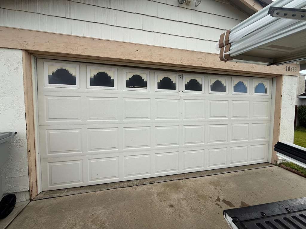 A white raised-panel door with cathedral windows
