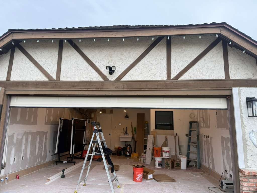 A sectional garage door stopped partially open